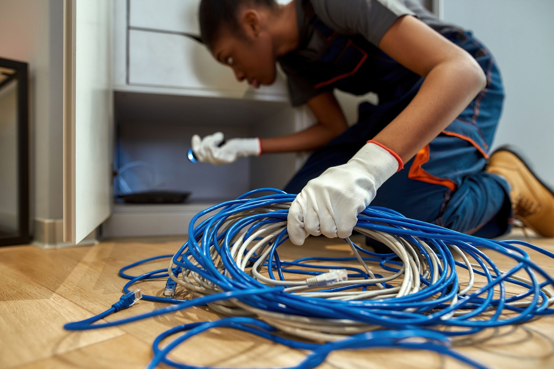 Bunch of Internet cables in female electrician's hand