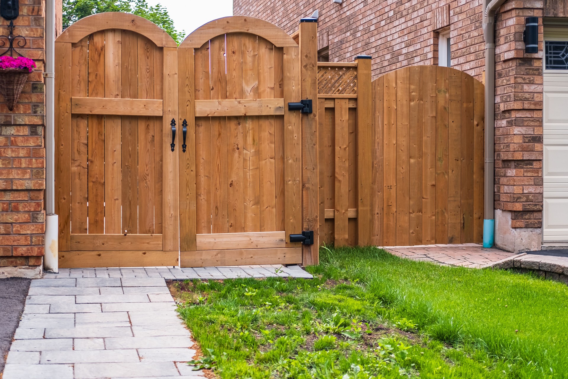 Front of a house with wooden gate. Backyard with wooden new gates. Gate, fence, home entrance.
