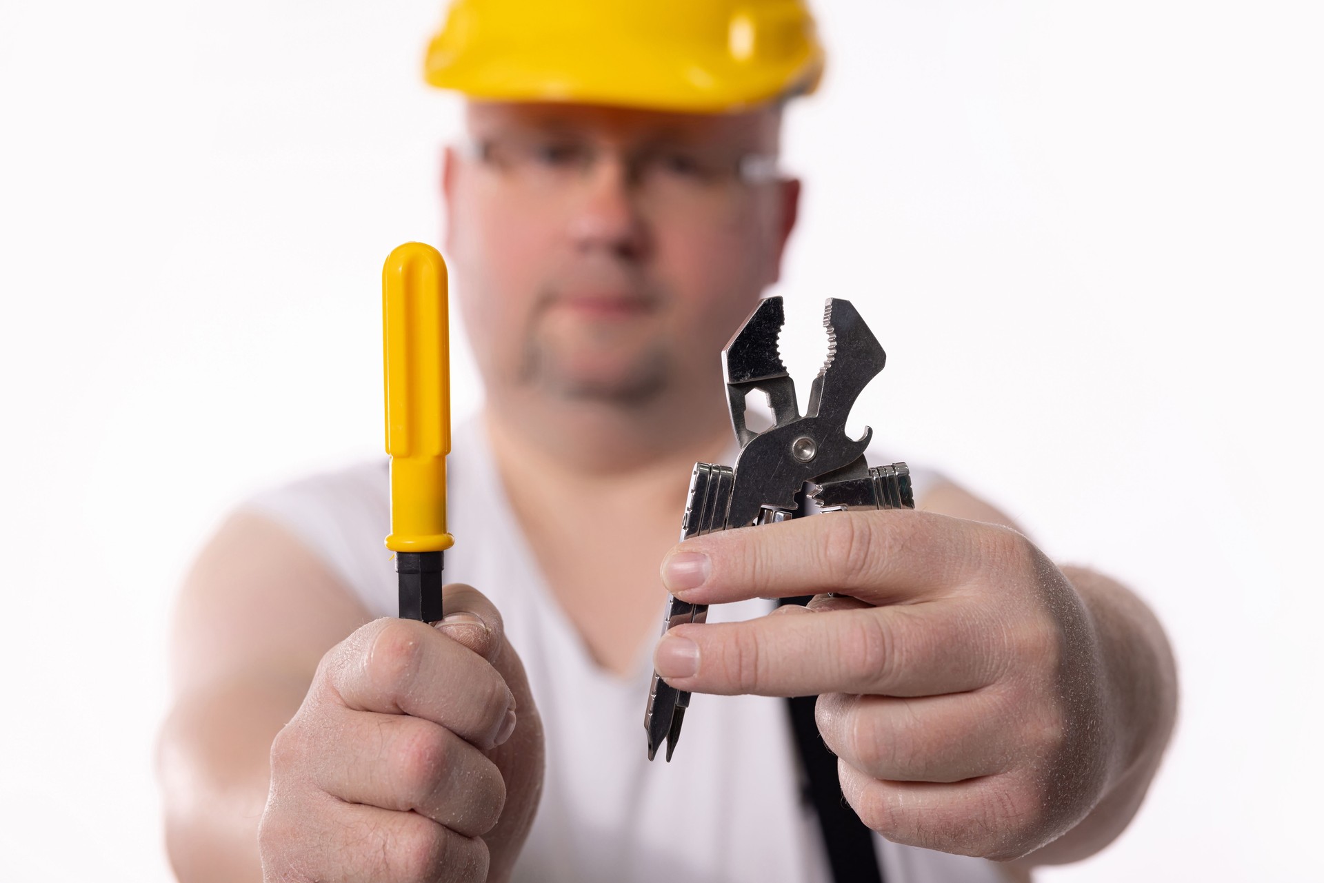 A construction worker grasping tools firmly in their hands, ready to tackle any project at hand